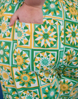 Close up of Juliet's hand in the back pocket of Spring Quilt Print Jumpsuit