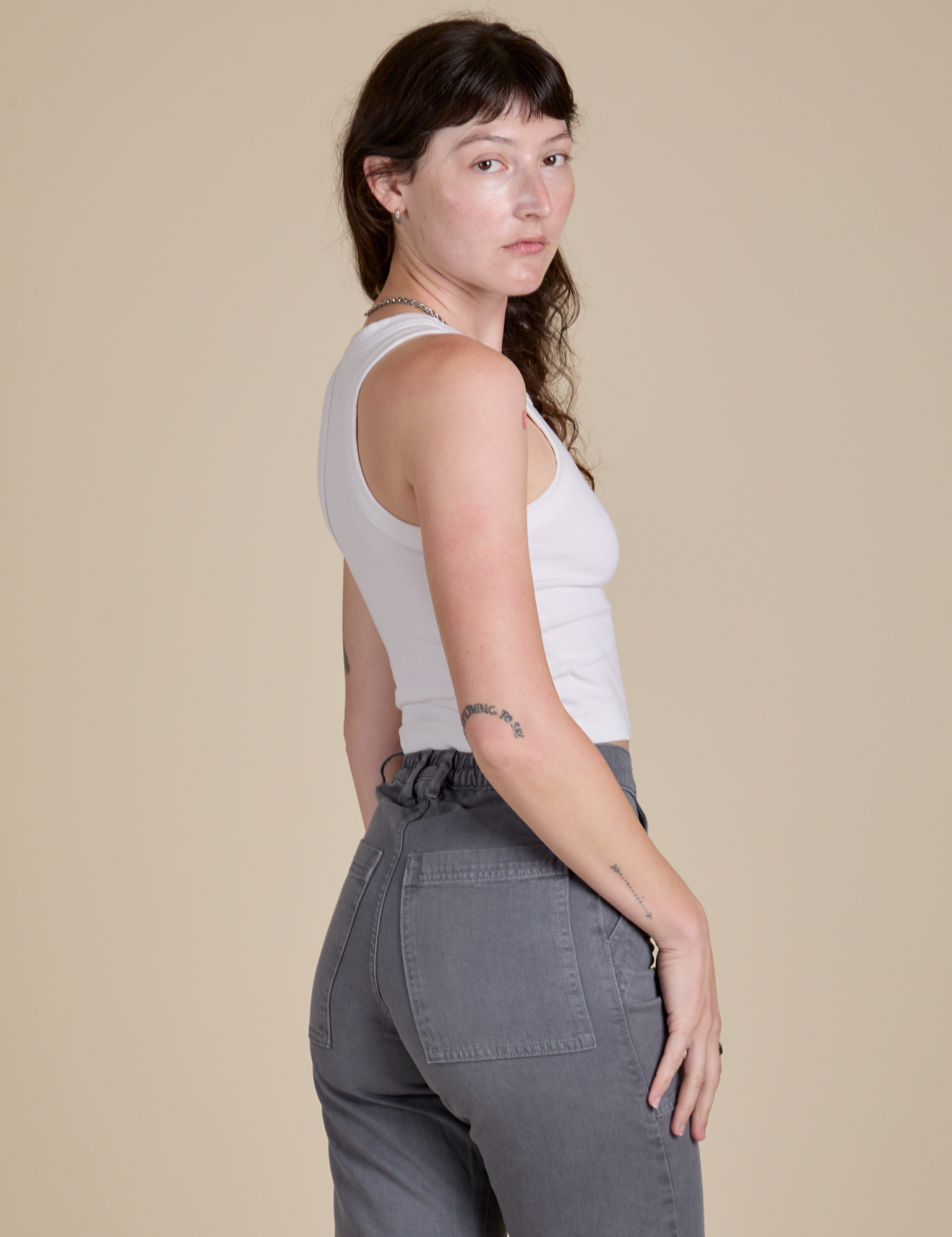 Racerback Tank in Vintage Tee White angled back view on Alex