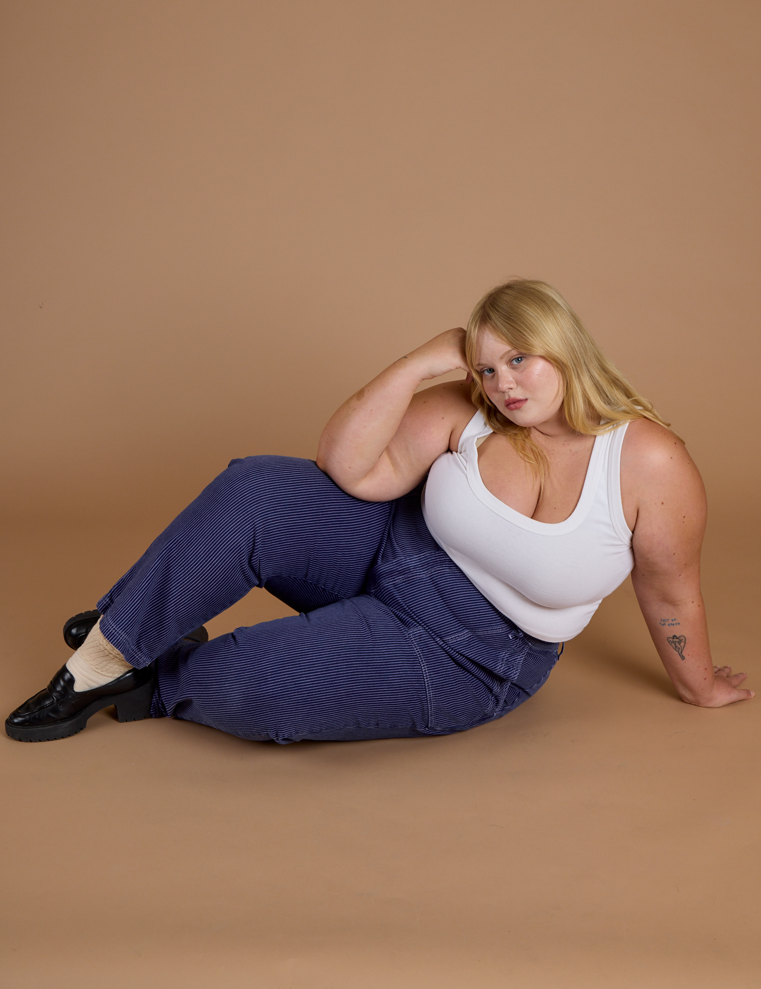 Juliet is wearing Railroad Denim Work Pants in Faded Grape Overdye and vintage tee white Cropped Tank