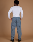 Back view of Railroad Denim Work Pants in Natural and vintage tee white long Sleeve Baby Tee