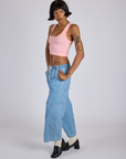 Angled front view of Cropped Tank Top in Baby Pink and light wash Denim Drop Pocket Pants