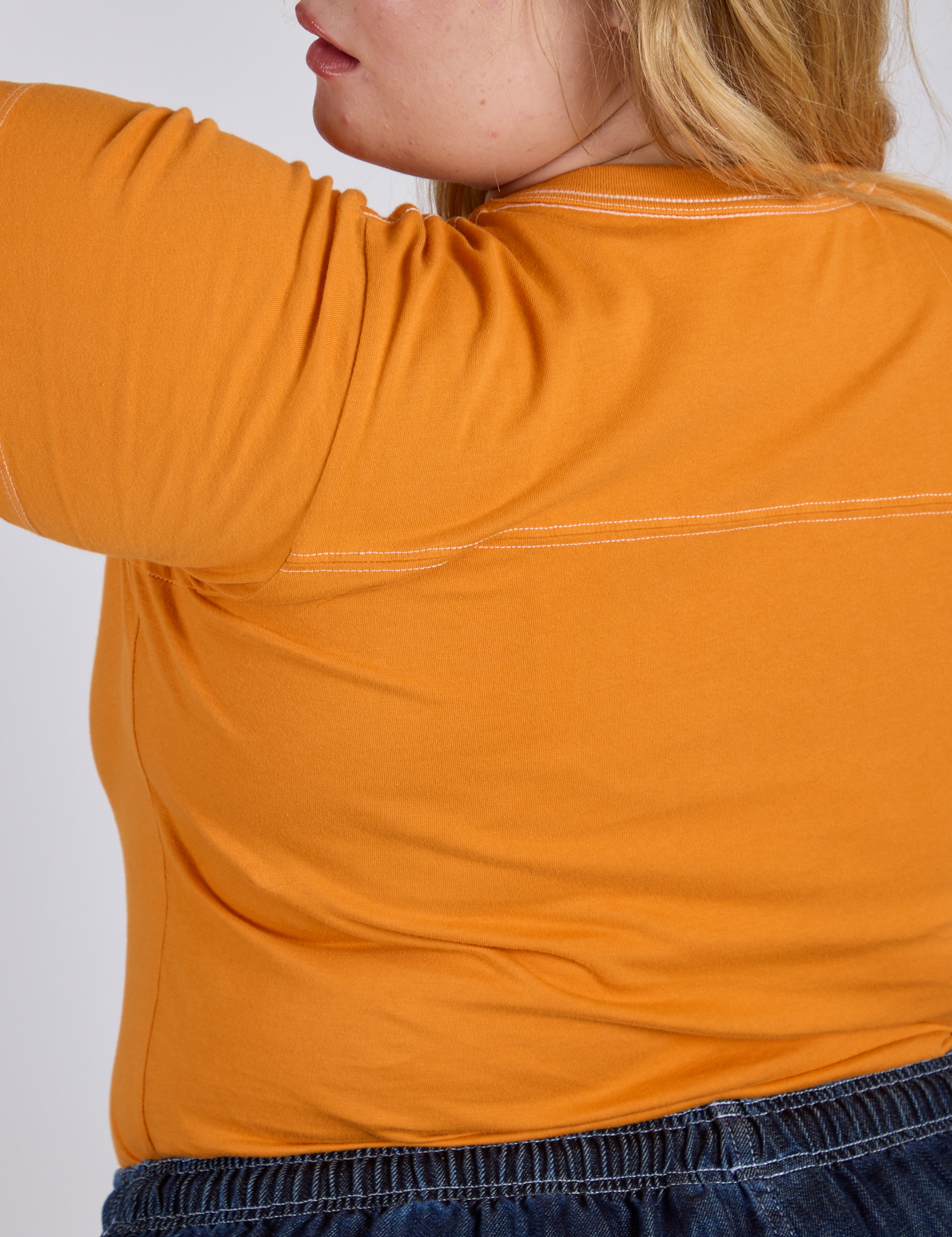 Jr. Varsity Tee in Creamsicle Orange back view close up on Juliet