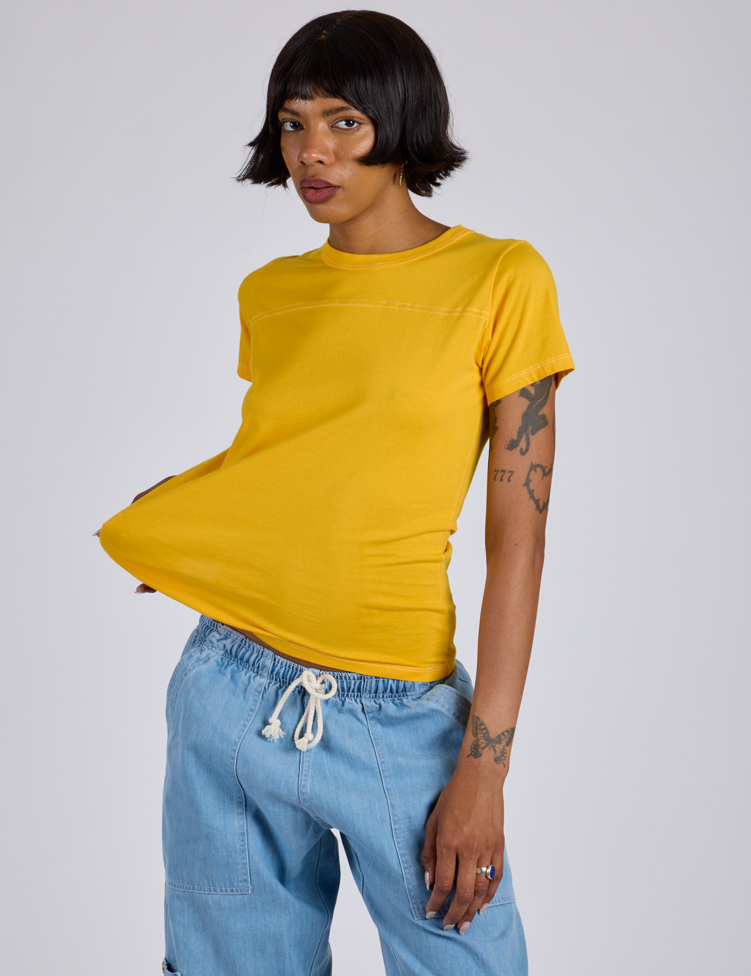 Kira is 5’10” and wearing P  Jr. Varsity Tee in Sunshine Yellow