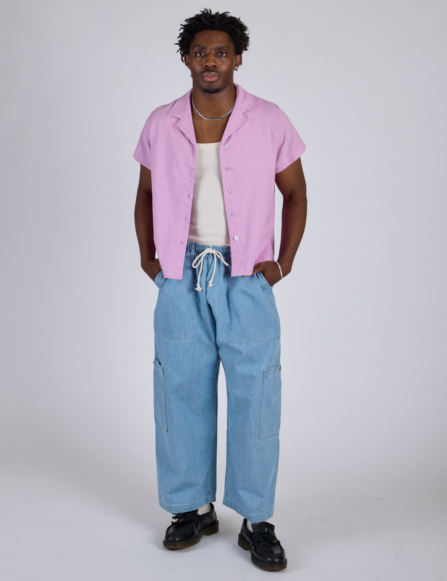 Isaac is wearing Pantry Button-Up in Lilac Purple and light wash Denim Drop Pocket Pants