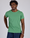 Isaac is 5’10” and wearing M Jr. Varsity Tee in Seafoam Green