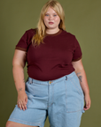 Juliet is wearing Vintage Ringer Tee in Red Wine tucked into light wash Carpenter Shorts