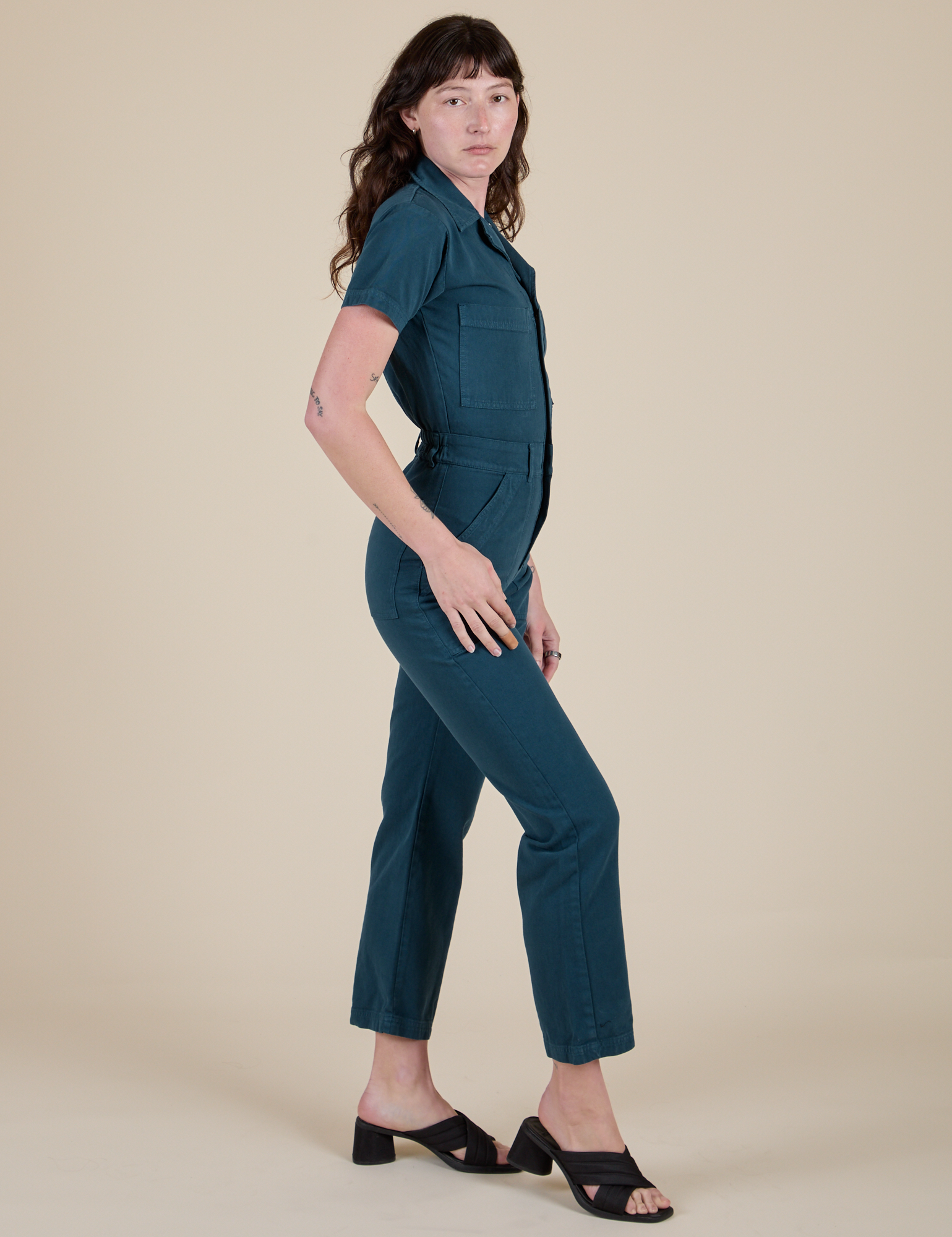 Side view of Short Sleeve Jumpsuit in Lagoon on Alex