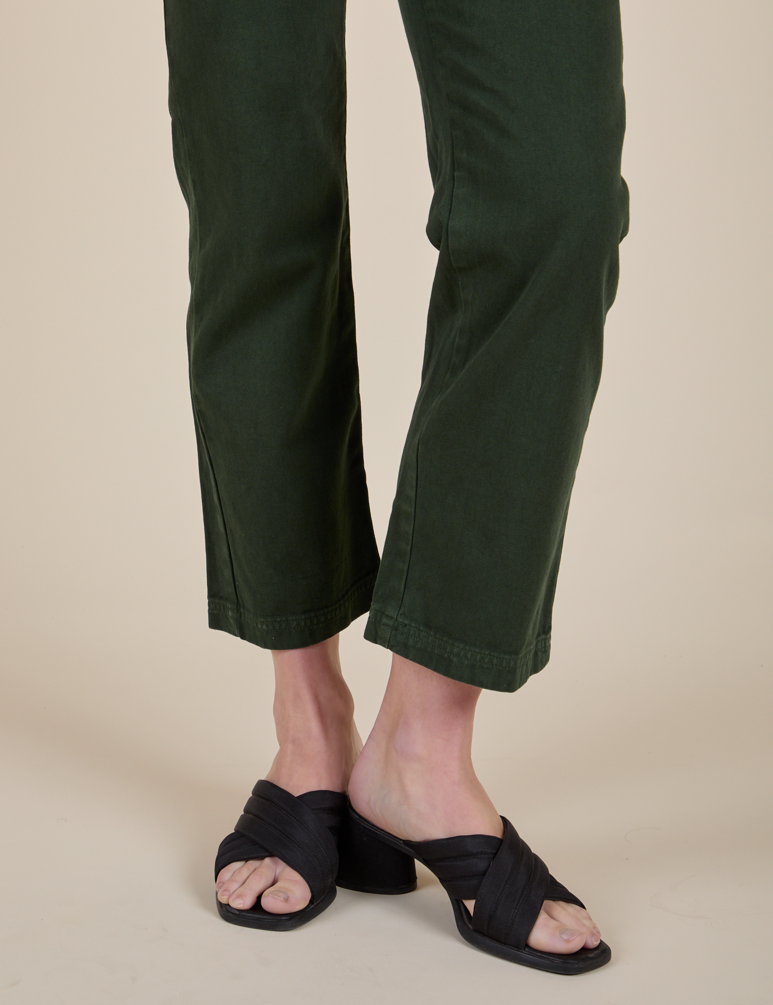 Short Sleeve Jumpsuit in Swamp Green pant leg close up on Alex
