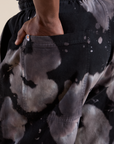Close up of Demi's hand in the back pocket of Magic Waters Drop Pocket Pants in Ink Blot