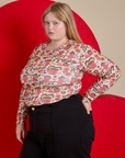 Angled front view of Long Sleeve Baby Tee in Hot Stuff Print on Juliet