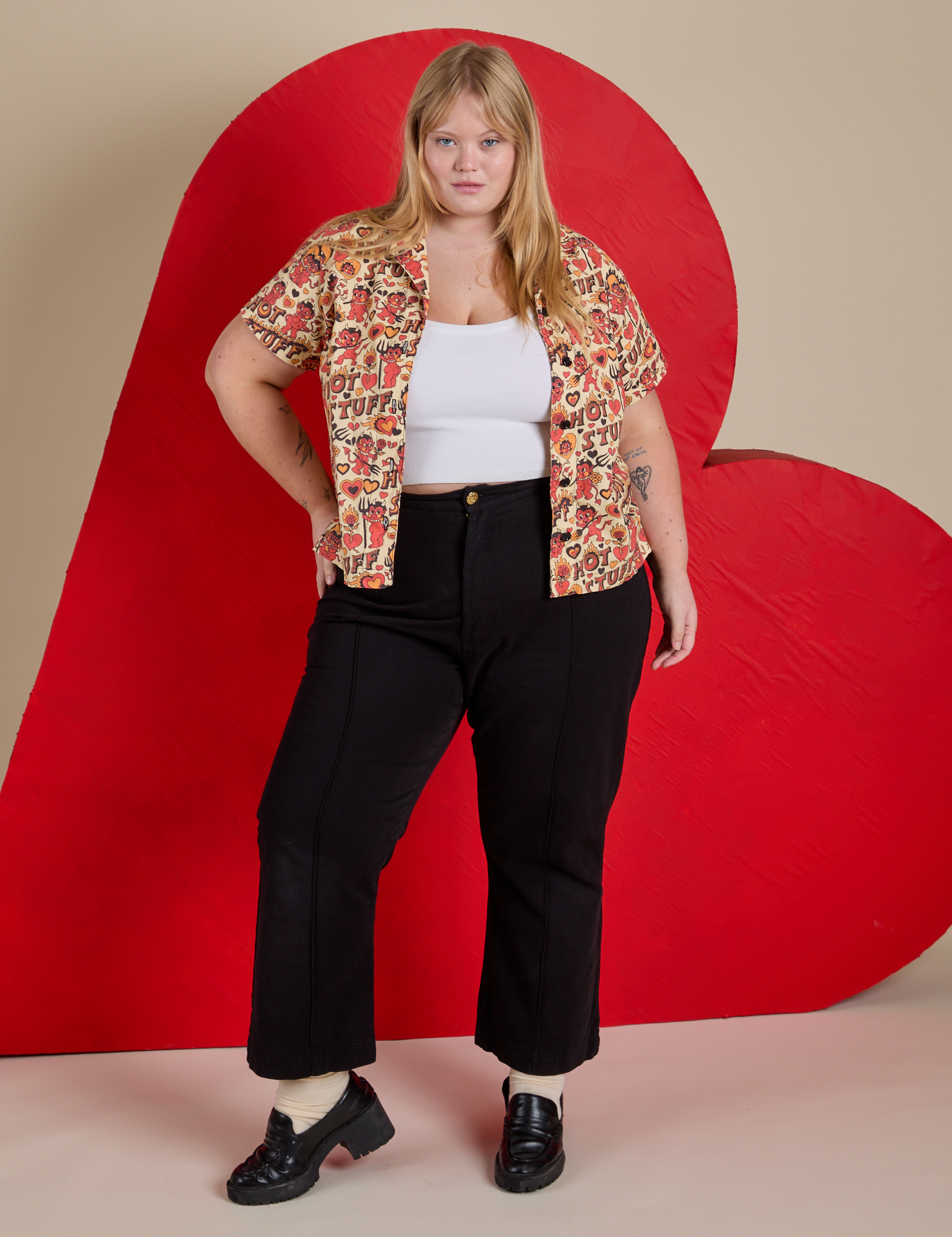 Juliet is wearing Hot Stuff Print Pantry Button-Up and black Western Pants