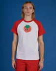 Grant is wearing Produce Raglan Tee in Tomato