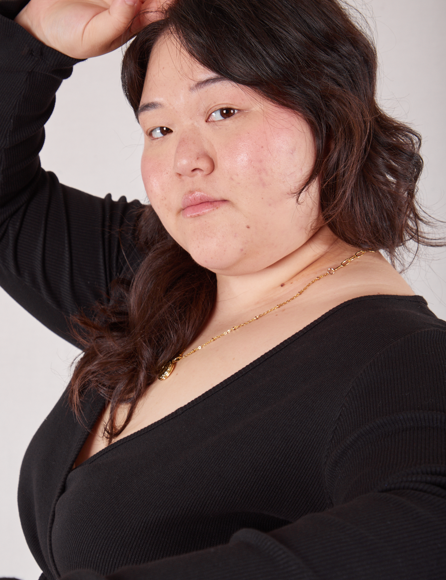 Ashley is wearing Wrap Top in Basic Black