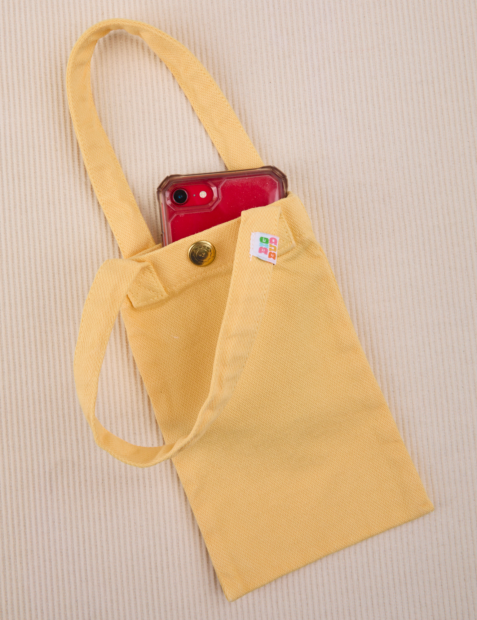 Phone tucked into butter yellow Cell Phone Tote