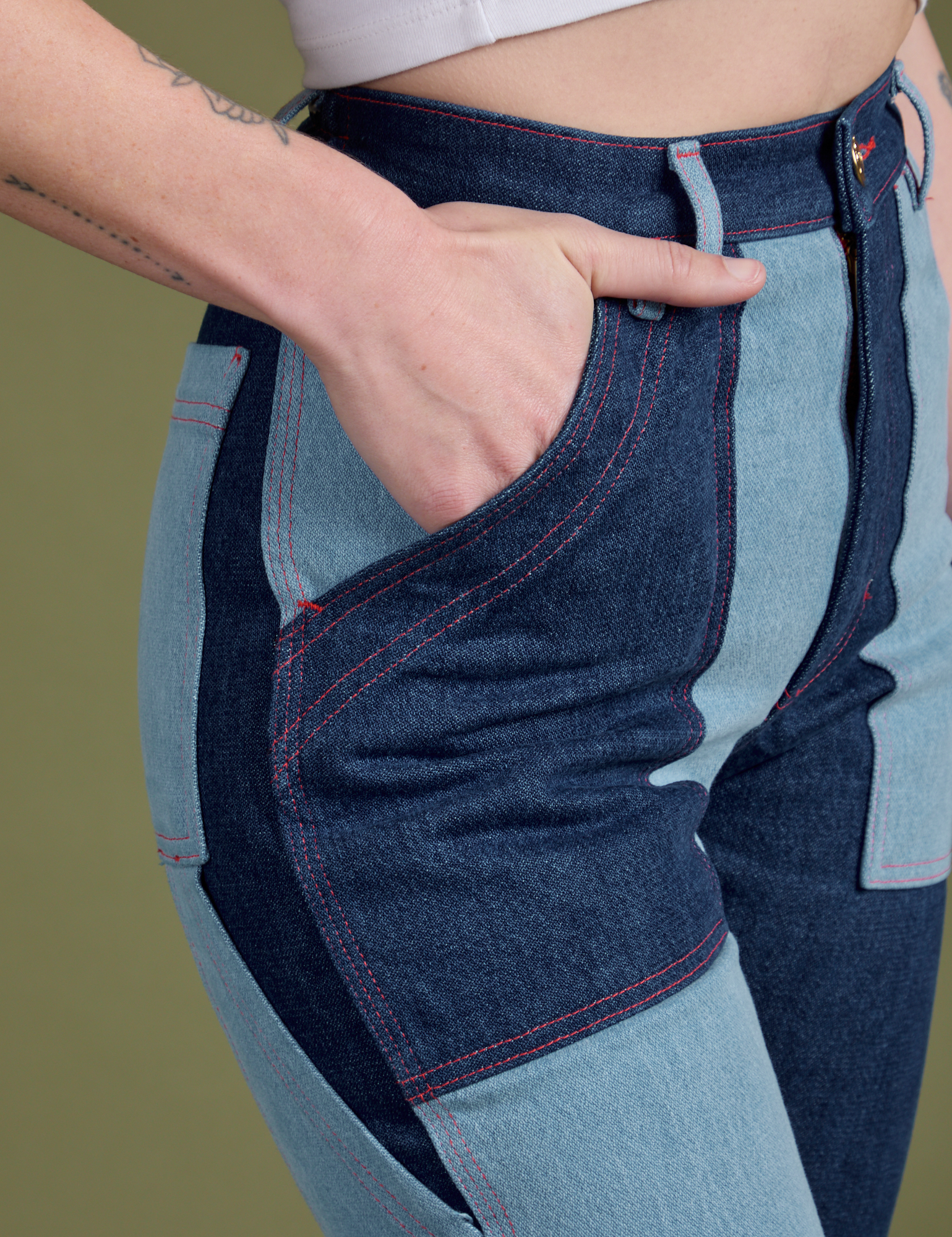 Close up of Alex's hand in the front pocket of Mismatched Denim Carpenter Jeans