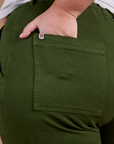 Close up of Juliet's hand in the back pocket of Organic Work Pants in Evergreen