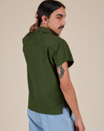 Angled back view of Pantry Button-Up in Evergreen on Anthony