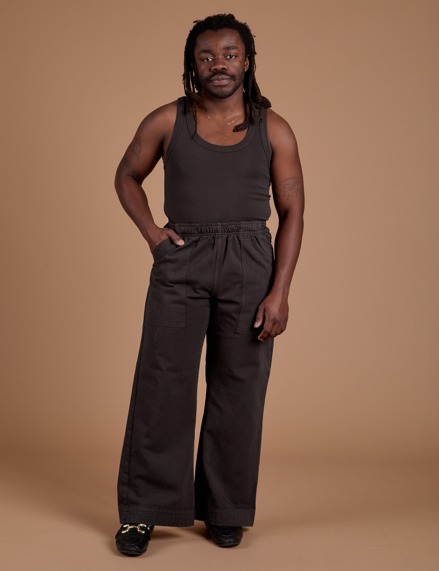 Demi is 5’6” and wearing S Work Pants in Espresso Brown paired with espresso brown Tank Top
