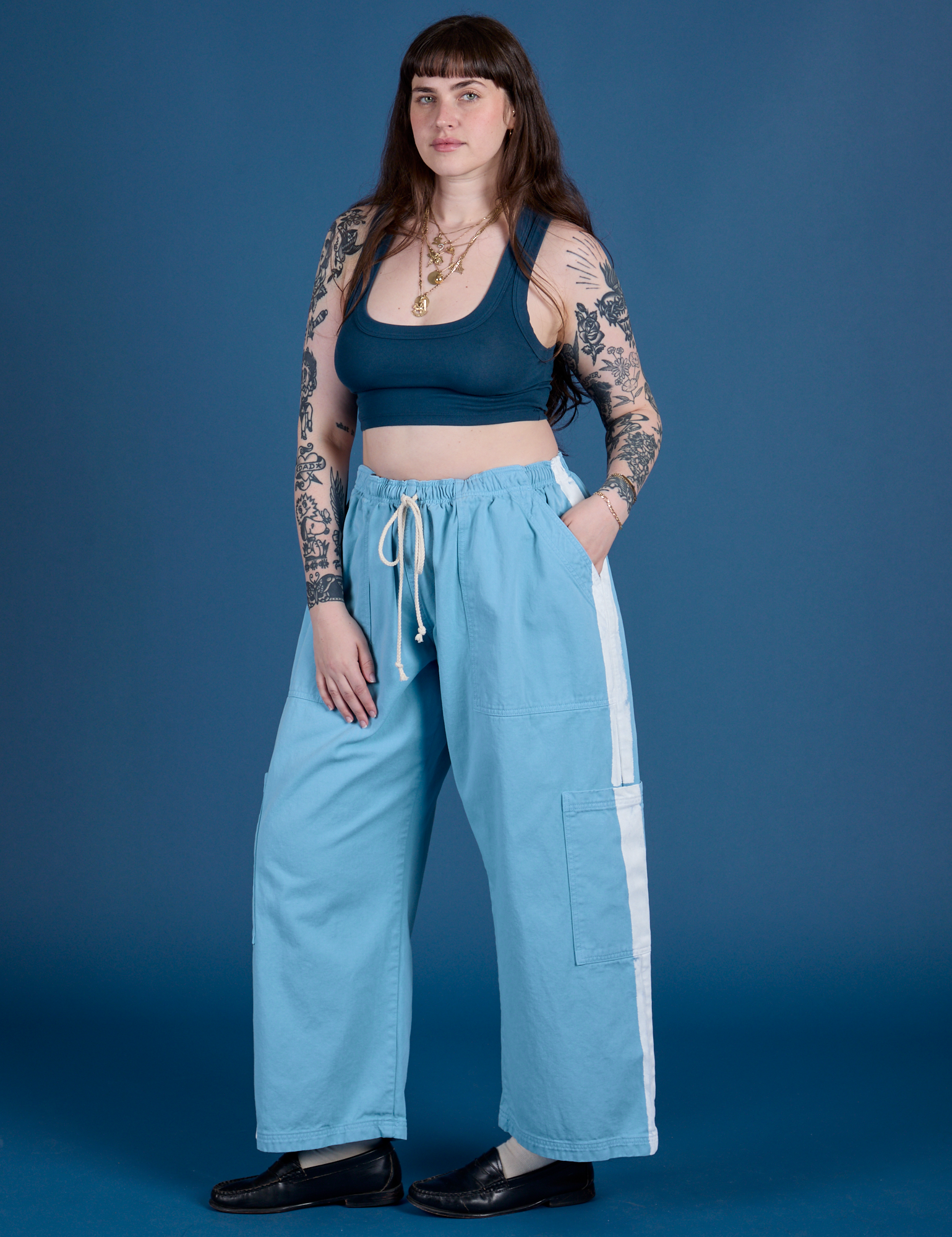 Angled front view of Painted Drop Pocket Cargo Pants in Baby Blue and lagoon Mini Tank on Sydney