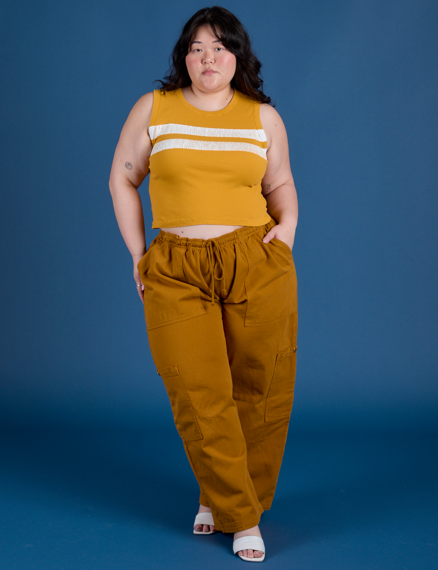 Ashley is wearing Painted Muscle Tee in Mustard Yellow and spicy mustard Drop Pocket Cargo Pants