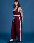Side view of and Painted Drop Pocket Cargo Pants in Red Wine matching Mini Tank on Sydney