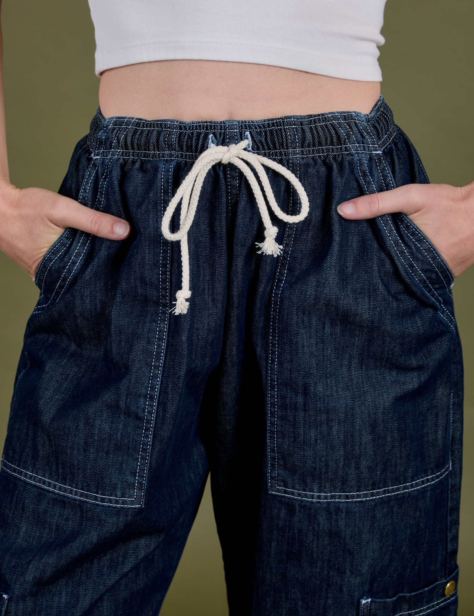 Close up of Denim Drop Pocket Pants in Dark Wash with Alex's hands in the front pockets