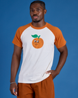 Issac is 5’10” and wearing M Produce Raglan Tee in Orange