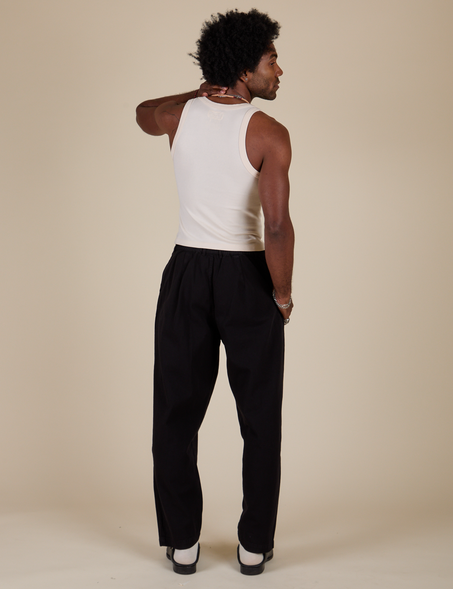 Back view of Heavyweight Trousers in Basic Black and Tank Top in Vintage Tee Off-White