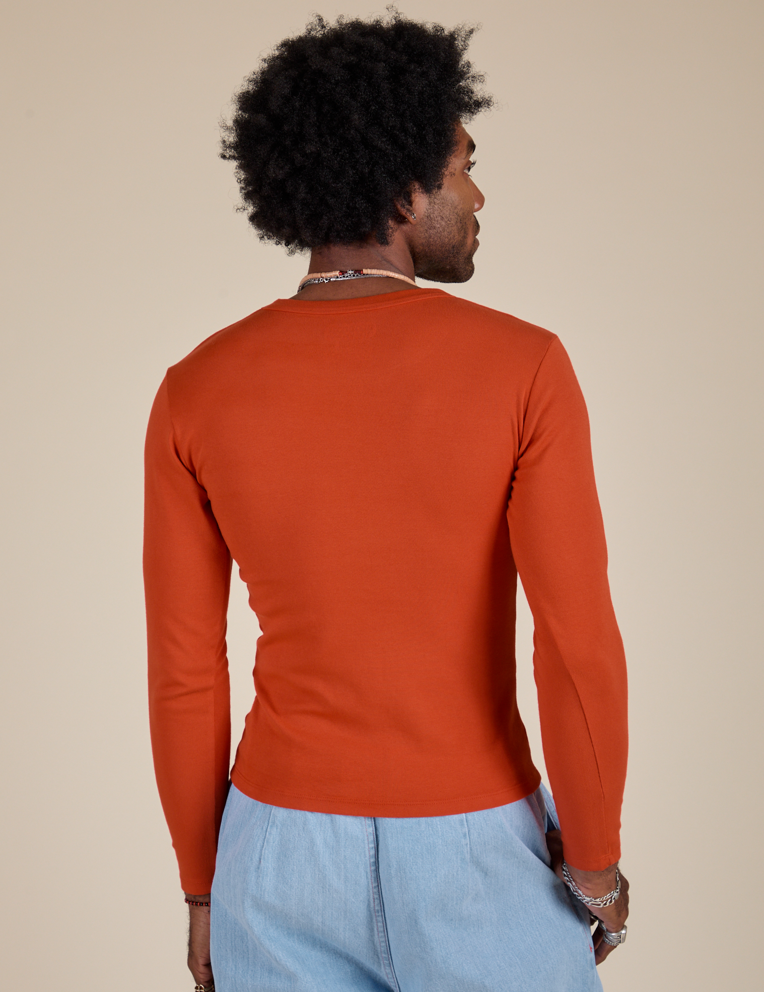 Long Sleeve Baby Tee in Chili Red back view on Jerrod