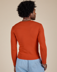 Long Sleeve Baby Tee in Chili Red back view on Jerrod