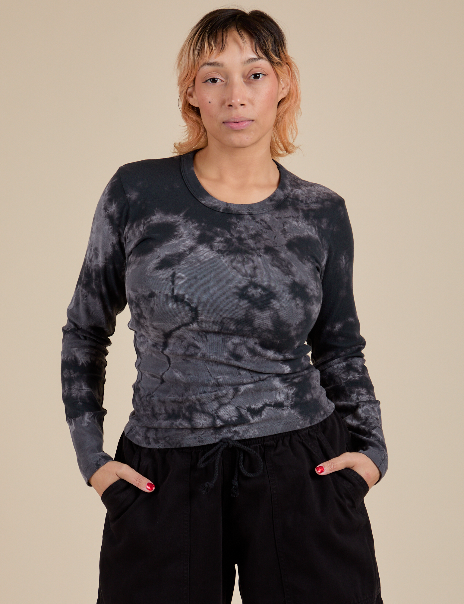 Tiara is 5’4” and wearing S Long Sleeve Baby Tee in Black Magic Waters