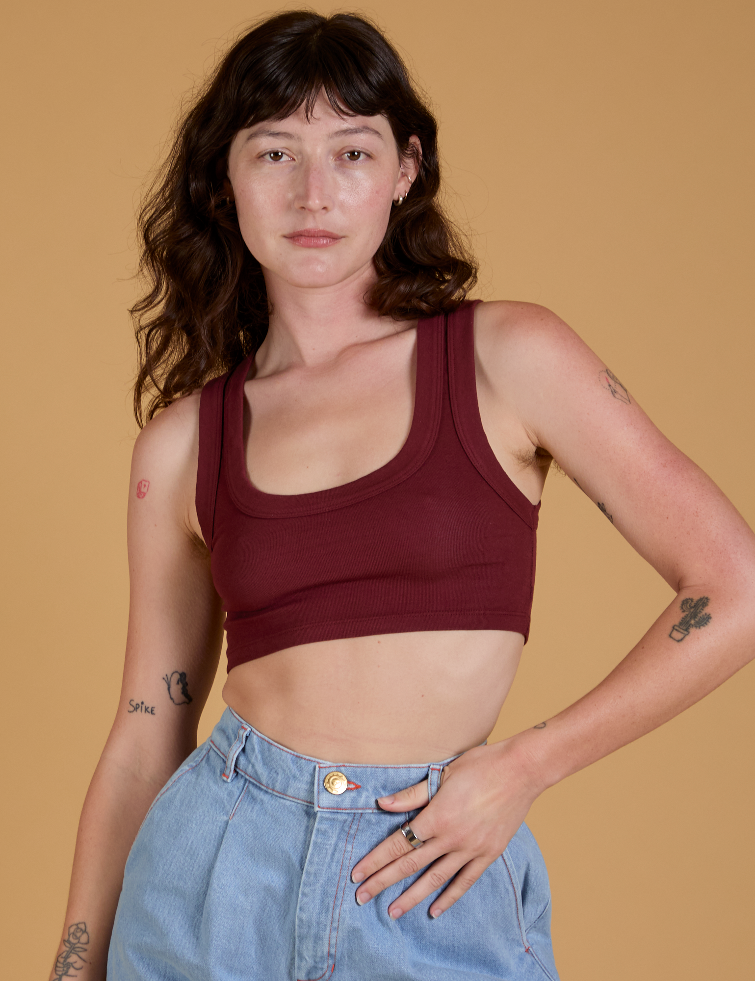 Alex is 5’8” and wearing P Mini Tank in Red Wine