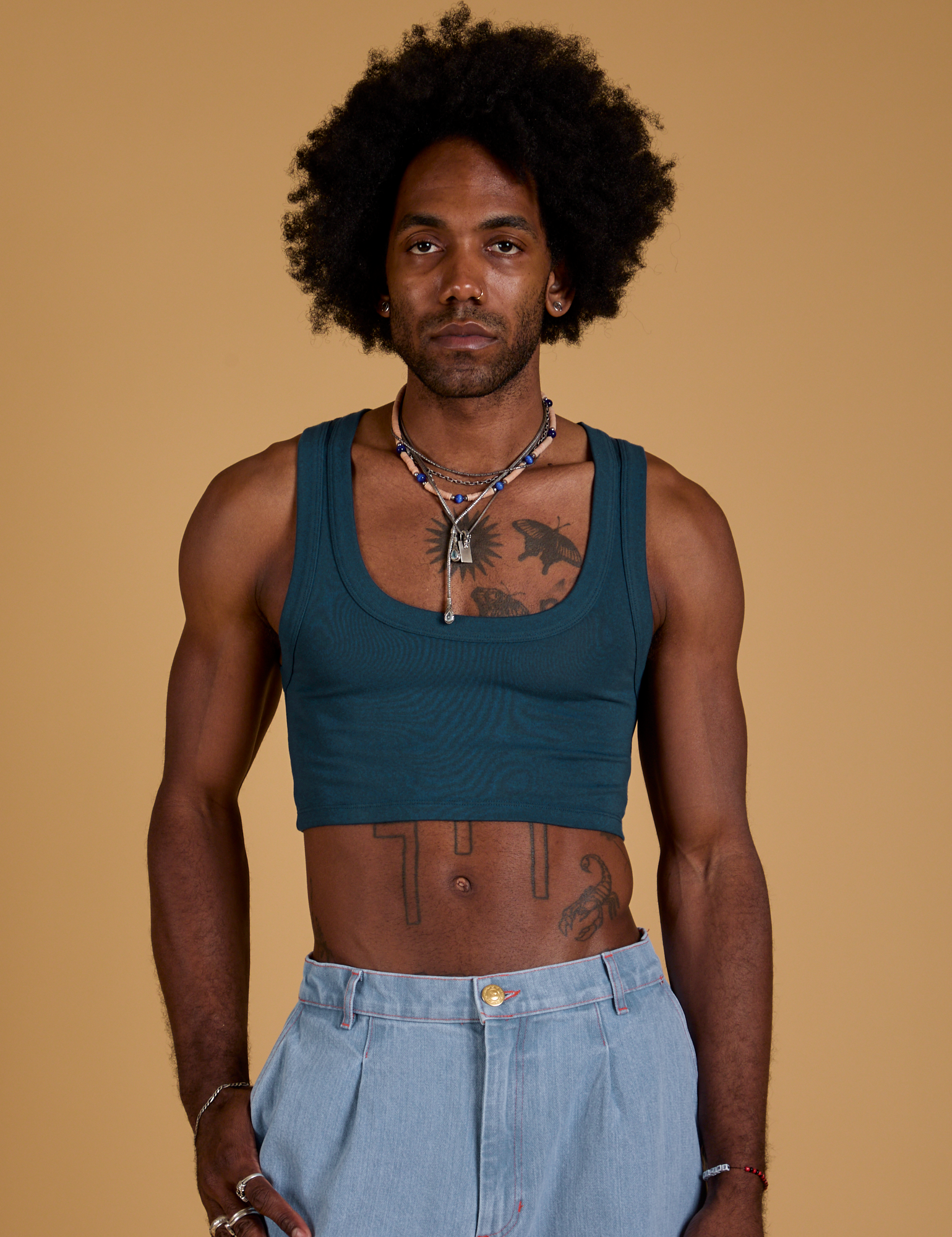 Jerrod is 6’3” and wearing S Mini Tank in Lagoon
