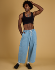 Jerrod is wearing Contrast Stitch Mini Tank in Basic Black and light wash Denim Drop Pocket Pants