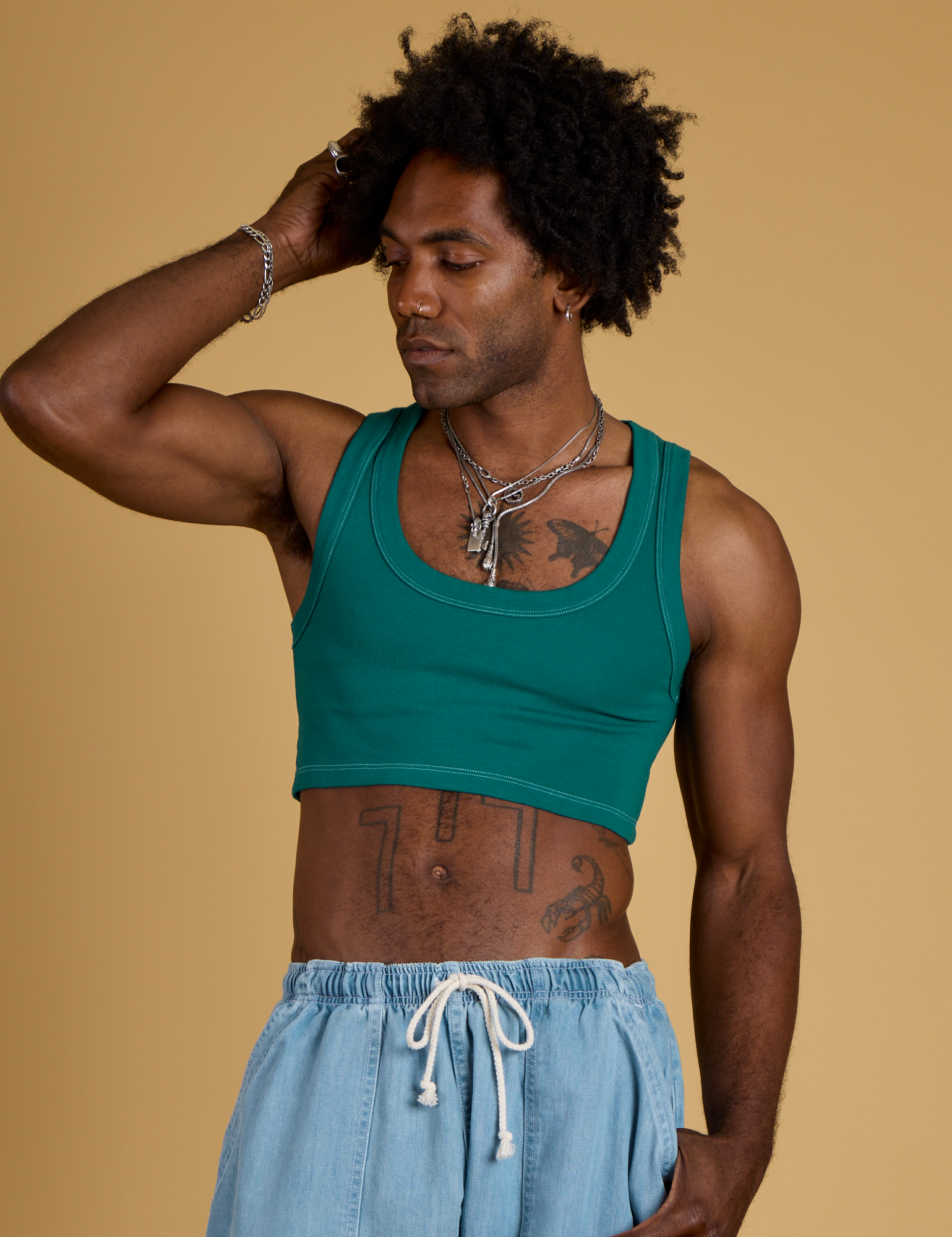 Jerrod is 6’3” and wearing M Contrast Stitch Mini Tank in Hunter Green