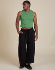 Isaac is wearing Muscle Tee in Seafoam Green paired with black Drop Pocket Cargo Pants