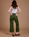 Back view of Organic Action Pants in Evergreen and vintage tee white Cropped Tank