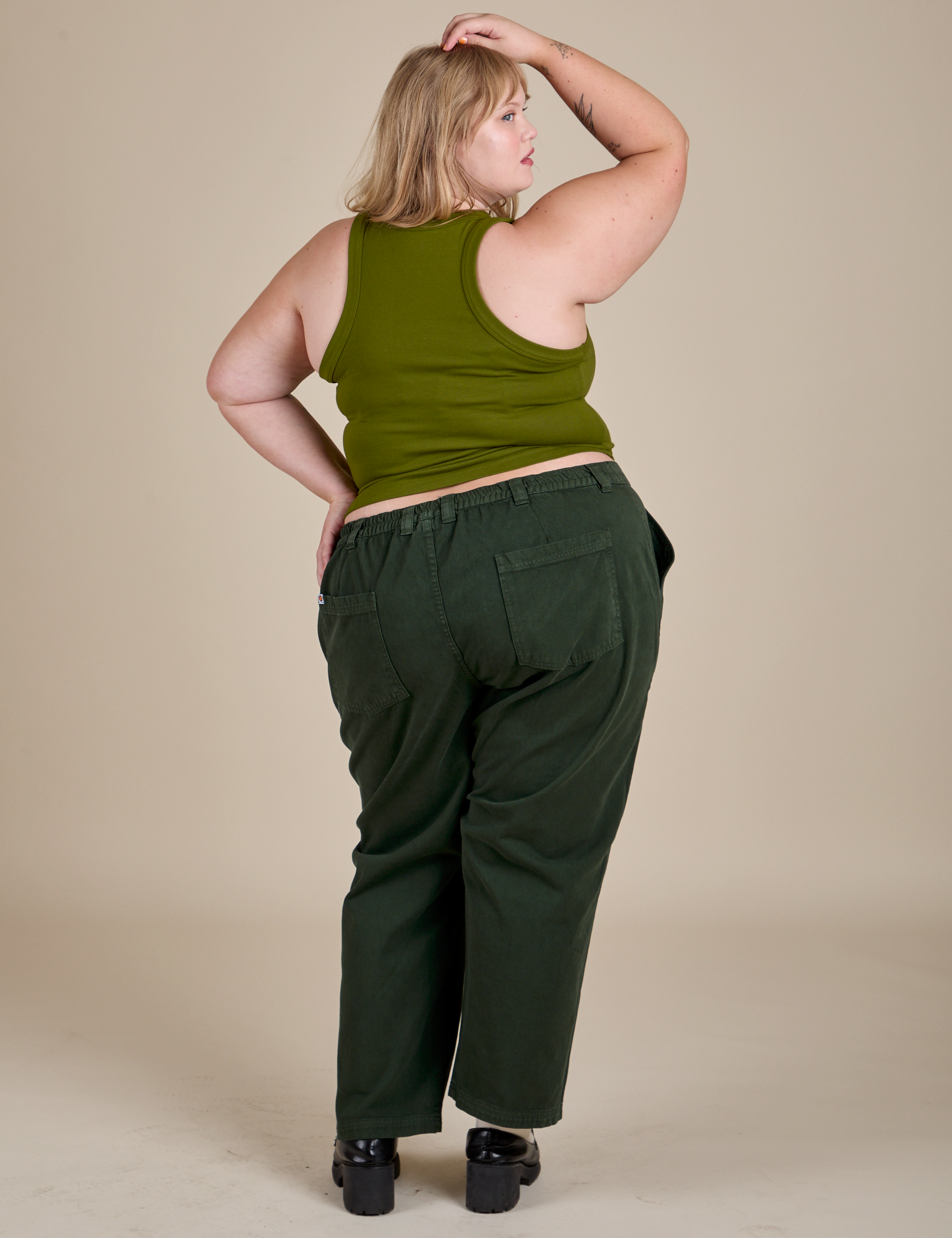 Racerback Tank in Summer Olive and swamp green Work Pants back view on Juliet