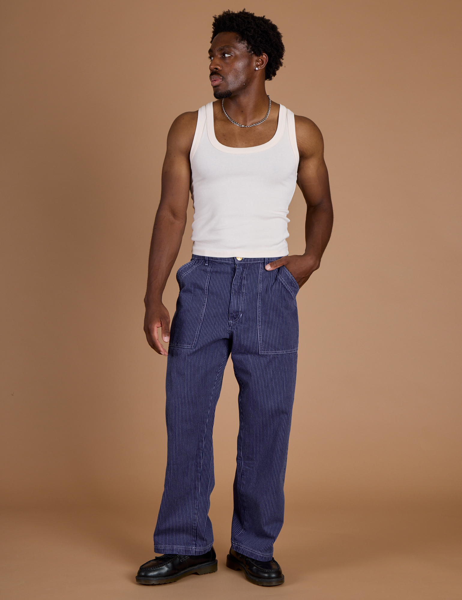 Isaac is 5’10” and wearing M Railroad Denim Work Pants in Faded Grape Overdye paired with vintage tee off-white Tank Top