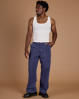 Isaac is 5’10” and wearing M Railroad Denim Work Pants in Faded Grape Overdye paired with vintage tee off-white Tank Top