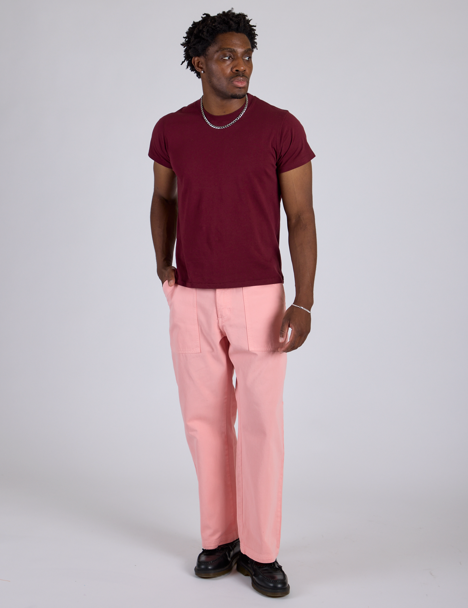 Isaac is 5’10” and wearing M Work Pants in Baby Pink paired with a red wine Organic Vintage Tee