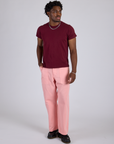 Isaac is 5’10” and wearing M Work Pants in Baby Pink paired with a red wine Organic Vintage Tee