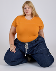 Jr. Varsity Tee in Creamsicle Orange and dark wash Denim Drop Pocket Pants on Juliet