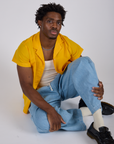 Pantry Button-Up in Sunshine Yellow and light wash Denim Drop Pocket Pants on Isaac