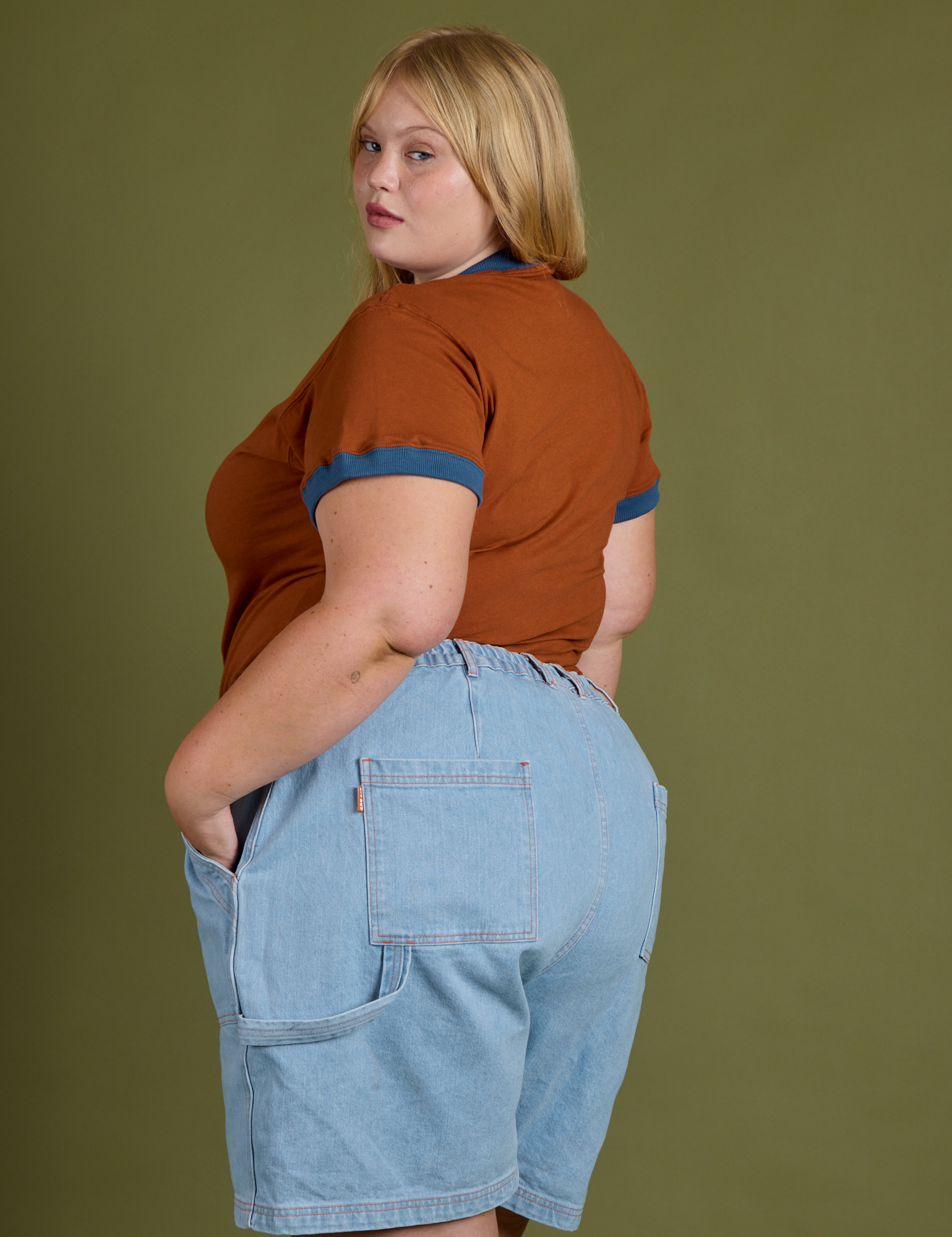 Angled back view of Vintage Ringer Tee in Burnt Terracotta and light wash Carpenter Shorts