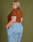 Angled back view of Vintage Ringer Tee in Burnt Terracotta and light wash Carpenter Shorts