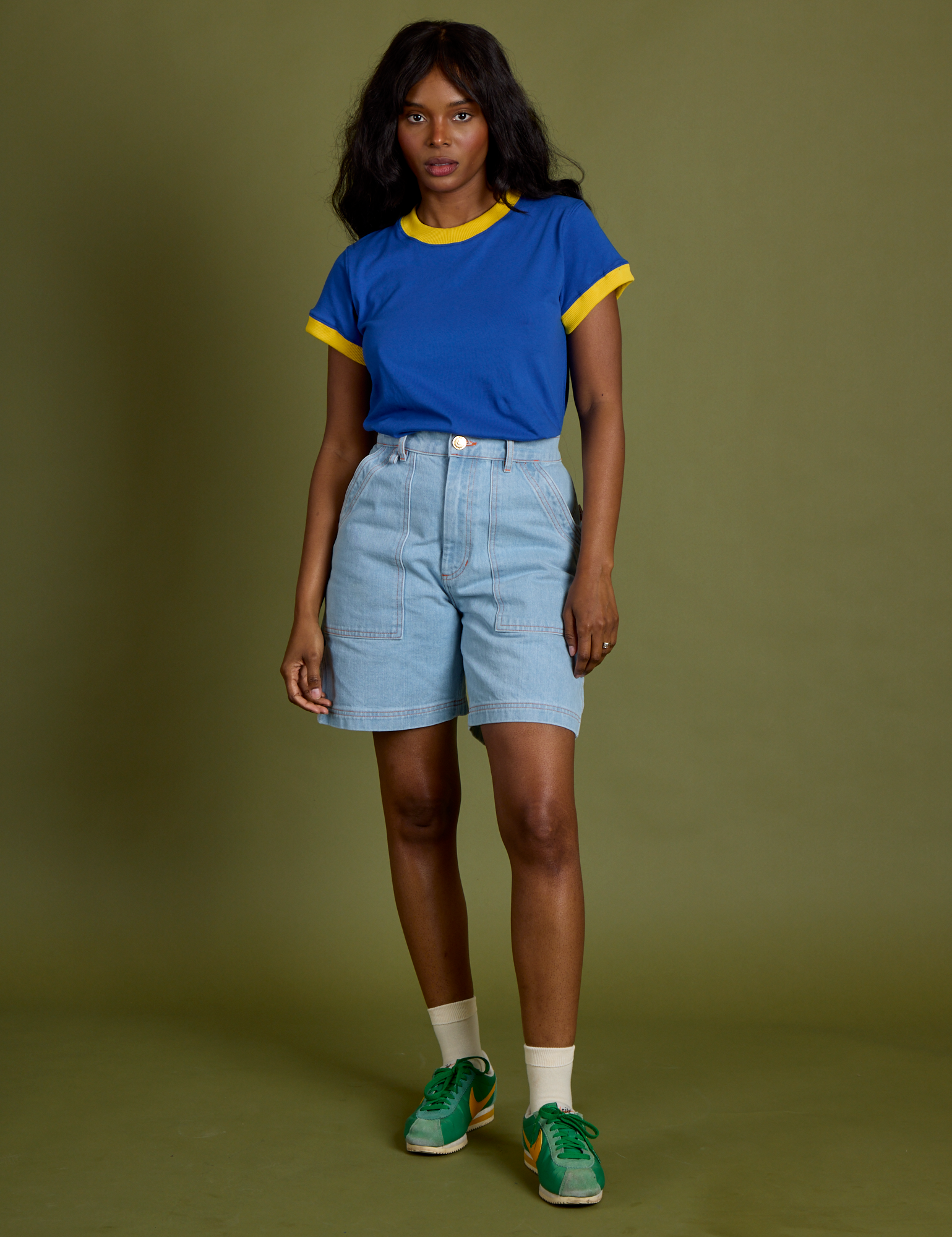 Kandia is 5’3” and wearing P Vintage Ringer Tee in Royal Blue paired with light wash Carpenter Shorts