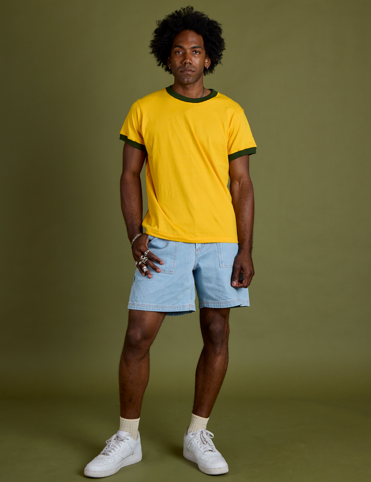 Jerrod is wearing Vintage Ringer Tee in Sunshine Yellow and light wash Carpenter Shorts