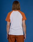 Back view of Produce Raglan Tee in Habanero on Grant