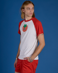 Angled front view of Produce Raglan Tee in Tomato on Grant